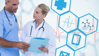 Two healthcare professionals consulting a medical chart with digital healthcare icons in the background.